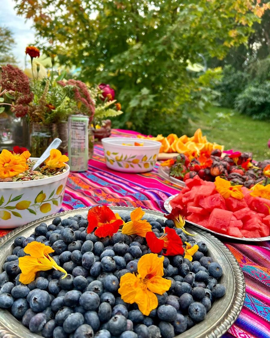 Platters of blueberries and watermelon topped with edible flowers